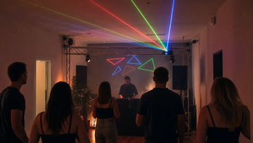 RGB laser fixture on a rear truss above a small DJ event