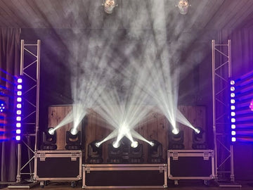 Moving head beam lights with haze on small stage truss setup